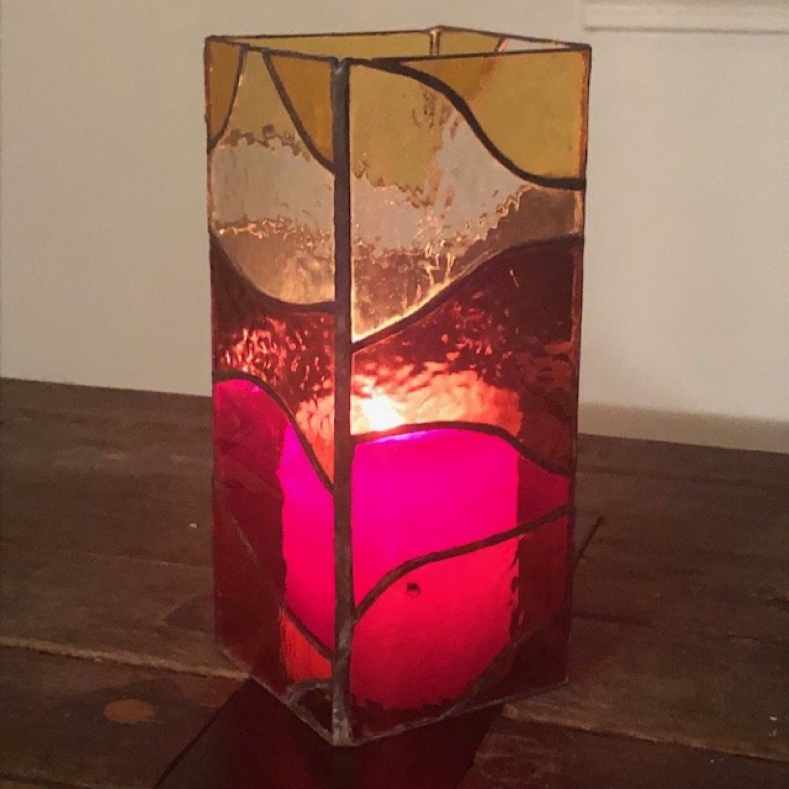 Stained glass candle holder glowing